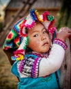 Young peruvian girl wearing traditional clothes on Uros island, Lake Titicaca, Peru Royalty Free Stock Photo