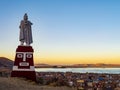 Lake Titicaca at sunset from Huajsapata Hill viewpoint with the monument to Manco Capac in foreground, Puno, Peru