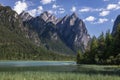 Lake Toblach with turquoise water and mountains of the Dolomite Alps during sunny summer day, South Tyrol Italy Royalty Free Stock Photo