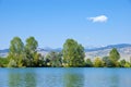 Lake, Trees, Mountains and Wispy Cloud