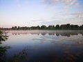 Lake with trees. Summer landscape by the river.Glassy surface of the water