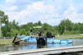 Lake vegetation harvester on shore