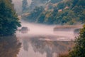 Lake view early in the morning before sunrise with fog above the Royalty Free Stock Photo