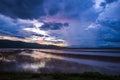 Lake view floating house boat of fishing village at sunset with cloud, rain and storm. Royalty Free Stock Photo