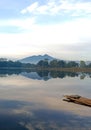 lake view in the morning with the reflection of the trees in the lake. the raft is on the edge of the photo