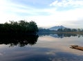 lake view in the morning with the reflection of the trees in the lake. the raft is on the edge of the photo