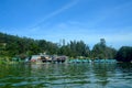 Lake view of Ootty, with lake shore, boats, buildings, trees and blue sky. Royalty Free Stock Photo