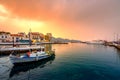 The lake Voulismeni in Agios Nikolaos, a picturesque coastal town with colorful buildings around the port.