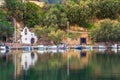 The lake Voulismeni in Agios Nikolaos, a picturesque coastal town with colorful buildings around the port.