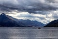 Lake Wakatipu view with a boat in the evening with sunlight over the mountains, Queenstown