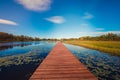 Lake water, pontoon, blue sky, white clouds, grass, reflection, autumn