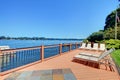 Lake waterfront deck with beach laying down chairs Royalty Free Stock Photo