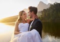 Lake, wedding and man carrying his bride while having an intimate moment together in nature. Happiness, love and young Royalty Free Stock Photo