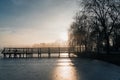 Lake in winter early morning with winter fogs in Zebrzydowice, Silesia, Poland with palace park, pier and frozen swimming pool. Royalty Free Stock Photo