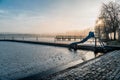 Lake in winter early morning with winter fogs in Zebrzydowice, Silesia, Poland with palace park, pier and frozen swimming pool. Royalty Free Stock Photo