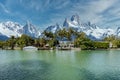 Lakefront homes with snow mountains in the background