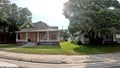 POV driving street pan S Florida Ave sun behind trees vintage southern home