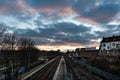 Laken, Brussels Capital Region - Belgium - Colorful clouds over the railway tracks at the local metro and train stop Pannenhuis - Royalty Free Stock Photo