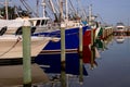 Lakes Entrance marina with moored boats reflected at sunset.