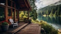 A lakeside cabin with a wooden porch overlooking a serene mountain lake.