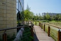 Lakeside fenced and planked path around building in sunny summer