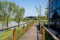Lakeside fenced and planked path outside building in sunny summer afternoon