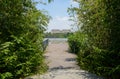 Lakeside fenced and planked platform with city in background on