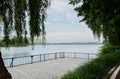 Lakeside fenced and planked platform in cloudy summer