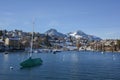 Lakeside homes and sailboat seen from a cruise boat at Lake Thun, Switzerland, Europe