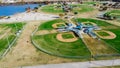 Aerial view lakeside huge baseball softball complex in natural grass fields, batting cages near Dallas, Texas