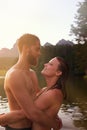 Lakeside love. an affectionate young couple hugging while swimming in a lake. Royalty Free Stock Photo