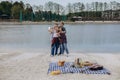 During lakeside picnic, friends capture moments on video and capture selfies.