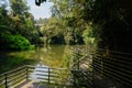 Lakeside planked path with steel railing in sunny spring afternoon