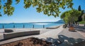 lakeside promenade Maderno, view to lake Gardasee, green branches, italy tourist resort