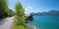 lakeside road Walchensee at springtime. shore with boathouse, mountain view