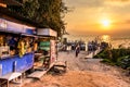 Lakeside stores, boats, jetties & volcano in golden hour, Lake Atitlan, Guatemala Royalty Free Stock Photo