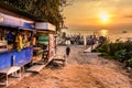 Lakeside stores, boats, jetties & volcano in golden hour, Lake Atitlan, Guatemala Royalty Free Stock Photo