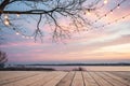 Lakeside sunset deck, string lights, bare tree, peaceful evening, event backdrop Royalty Free Stock Photo