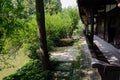 Lakeside verdant summer outside aged Chinese corridor