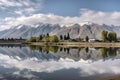 lakeside view, with reflection of towering mountains in the background