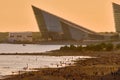 Lakhta Center and the Gulf of Finland at sunset. Saint Petersburg, Russia. People are walking on the beach.