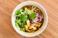 Laksa on wooden table. Laksa is a spicy noodle soup