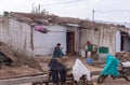 2 women work in front of house in Lakundi, Karnataka, India