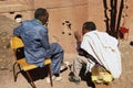 Pilgrims talk with the monolithic rock-hewn church at the background in Lalibela, Ethiopia.