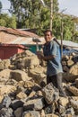 LALIBELA, ETHIOPIA - MARCH 29, 2019: Local worker breaking rocks on a road construction in Lalibela village, Ethiop