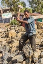 LALIBELA, ETHIOPIA - MARCH 29, 2019: Local worker breaking rocks on a road construction in Lalibela village, Ethiop
