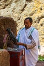 Man counts collected funds from the faithful outside St. George Church, Lalibela Ethiopia Royalty Free Stock Photo