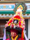 Lama in ritual costume and ornate hat performs Black Hat Dance of Tibetan Buddhism on the Cham Dance Festival