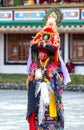 Lama in ritual costume and ornate hat performs Black Hat Dance of Tibetan Buddhism on the Cham Dance Festival