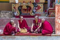 Four buddhist monk with colored red clothes during festival at Lamayuru monastry, Ladakh, India